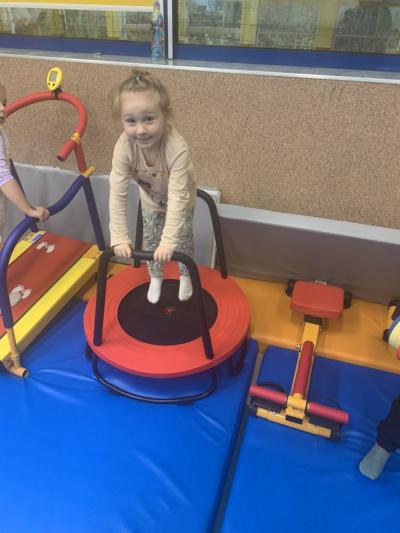 Dziewczynka skacze na mini trampolinie w sali ćwiczeń..jpg