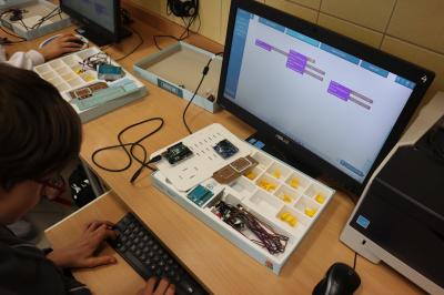 Uczniowie klasy VIb uczestniczą w zajęciach mechatroniki. Na stołach umieszczone są zestawy do nauki mechatroniki