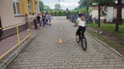 Uczennica  pokonuje na rowerze tor przeszkód