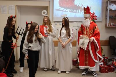 Uczniowie otrzymują i rozpakowywują prezenty od Świętego Mikołaja