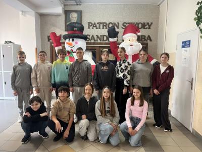 klasa 6b stoi na szkolnym korytarzu; z tyłu dmuchany mikołaj i bałwan.JPG