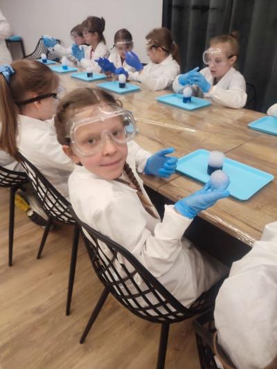 Dzieci biorą udział w warsztatach chemicznych
