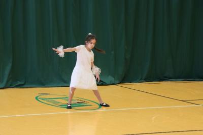 Uczennica tańczy na scenie.