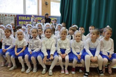 Przedszkolaki z grupy Biedronki pozują do zdjęcia siedząc obok sceny.