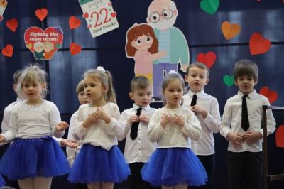 Przedszkolaki z grupy Biedronki występują na scenie w biało-niebieskich strojach