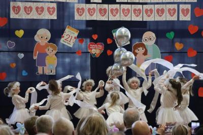 Przedszkolaki z grupy Skrzaty występują na scenie w białych strojach