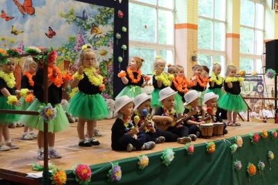Przedszkolaki w kolorowych strojach występują na scenie z okazji Święta Rodziny