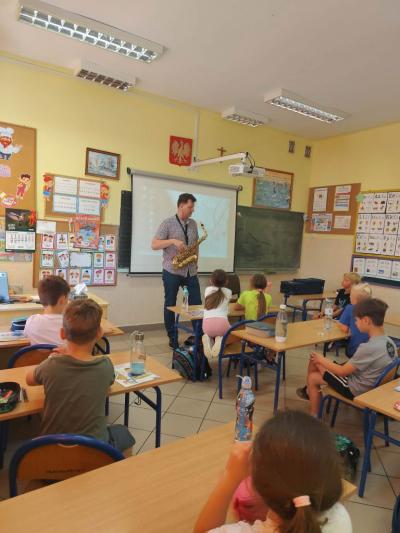 Pan Marek przedstawia uczniom historię instrumentu.