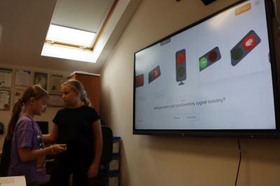 Uczniowie obsługują monitor interaktywny.